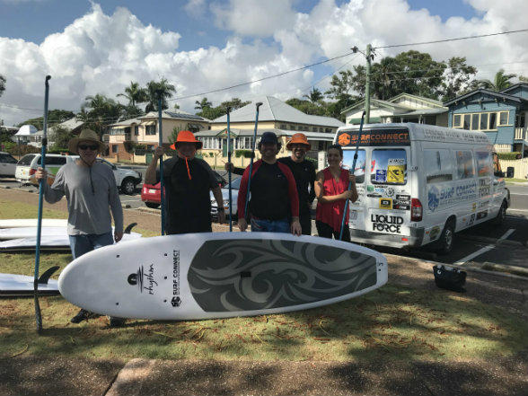 Participants from the Stand Together paddle-board program 