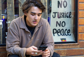 A young man texting.