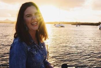 A woman smiling on a boat