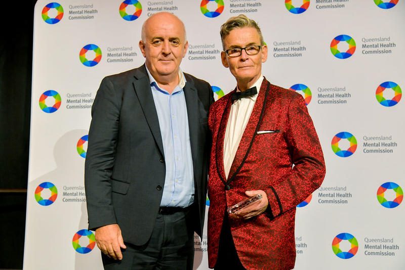 Stephen Kelly standing with Commissioner Ivan Frkovic receiving the award